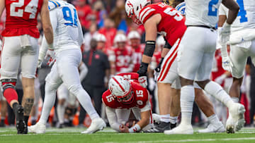 Nebraska quarterback Dylan Raiola is helped up by offensive lineman Bryce Benhart after being sacked for a 10-yard loss on 4th-and-5 by UCLA.