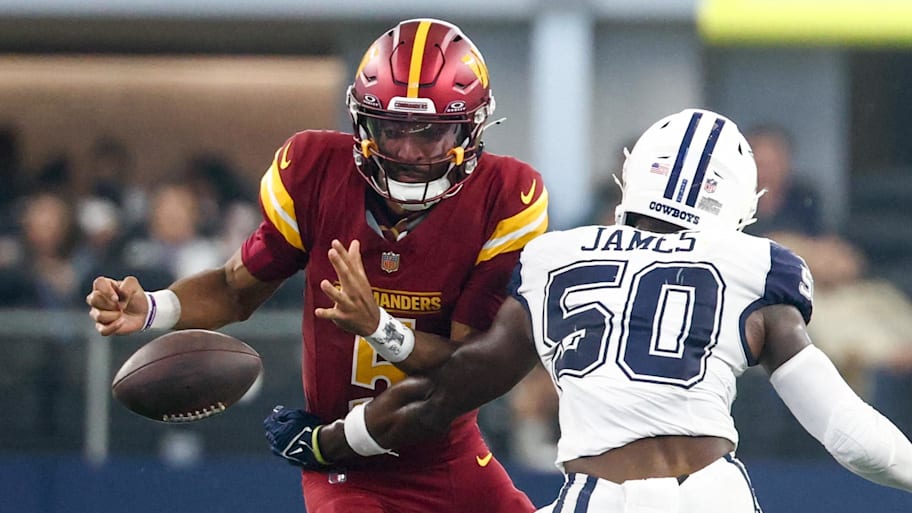 Washington Commanders quarterback Jayden Daniels (5) fumbles the ball defended by Dallas Cowboys linebacker Shemar James