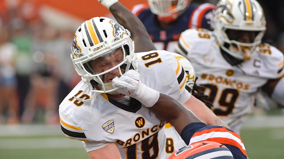 Western Michigan safetty Micah Davis tackles an Illini ball carrier.