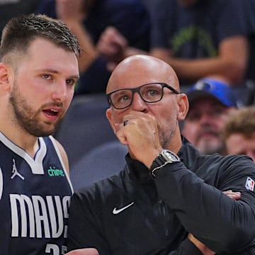 Dallas Mavericks guard Luka Doncic and head coach Jason Kidd talk during a game.