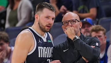 Oct 29, 2024; Minneapolis, Minnesota, USA; Dallas Mavericks guard Luka Doncic (left) and head coach Jason Kidd talk during the game against the Minnesota Timberwolves in the fourth quarter at Target Center. Mandatory Credit: Brad Rempel-Imagn Images