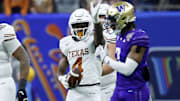 Jan 1, 2024; New Orleans, LA, USA; Texas Longhorns running back CJ Baxter (4) gestures after a play against the Washington Huskies during the first quarter the 2024 Sugar Bowl college football playoff semifinal game at Caesars Superdome. Mandatory Credit: Geoff Burke-Imagn Images
