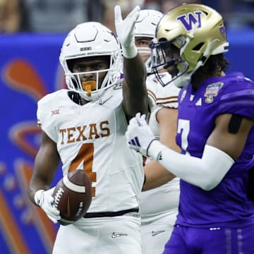 Jan 1, 2024; New Orleans, LA, USA; Texas Longhorns running back CJ Baxter (4) gestures after a play against the Washington Huskies during the first quarter the 2024 Sugar Bowl college football playoff semifinal game at Caesars Superdome. Mandatory Credit: Geoff Burke-Imagn Images