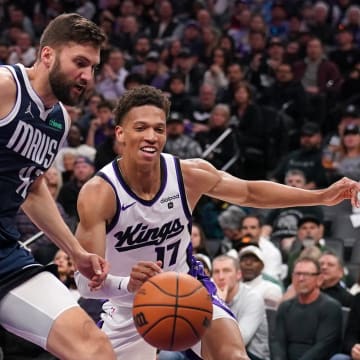 Mar 29, 2024; Sacramento, California, USA; Dallas Mavericks forward Maxi Kleber (42) and Sacramento Kings forward Kessler Edwards (17) attempt to gain control of a loose ball in the third quarter at the Golden 1 Center. Mandatory Credit: Cary Edmondson-USA TODAY Sports