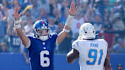 Sep 28, 2025; East Rutherford, New Jersey, USA; New York Giants quarterback Jaxson Dart (6) celebrates a two point conversion against the Los Angeles Chargers in front of Chargers defensive end da'Shawn Hand (91) during the third quarter at MetLife Stadium. Mandatory Credit: Brad Penner-Imagn Images