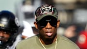 Nov 11, 2023; Boulder, Colorado, USA; Colorado Buffaloes head coach Deion Sanders runs on to the field before the first half against the Arizona Wildcats at Folsom Field. Mandatory Credit: Ron Chenoy-Imagn Images