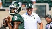 Michigan State's offensive coordinator Brian Lindgren, right, watches as Aidan Chiles warms up before the football game against Prairie View A&M on Saturday, Sept. 14, 2024, at Spartan Stadium in East Lansing.