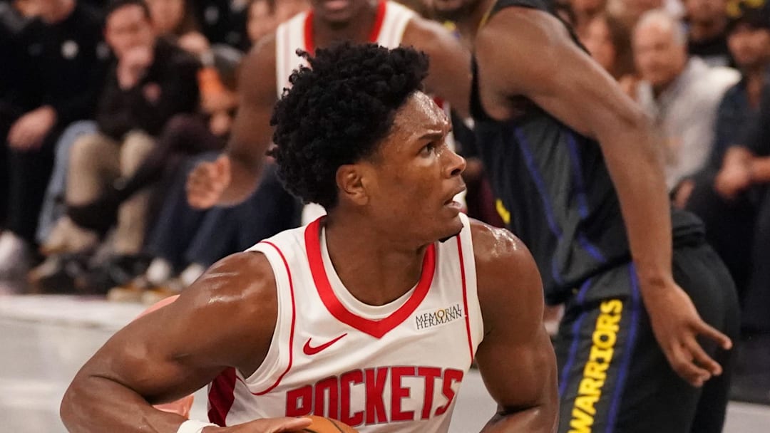 Nov 26, 2025; San Francisco, California, USA;  Houston Rockets guard-forward Amen Thompson (1) drives to the basket while defended by Golden State Warriors guard Stephen Curry (30) in the fourth quarter at Chase Center. Mandatory Credit: David Gonzales-Imagn Images