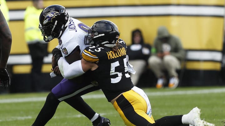 Oct 8, 2023; Pittsburgh, Pennsylvania, USA; Pittsburgh Steelers linebacker Cole Holcomb (55) sacks Baltimore Ravens quarterback Lamar Jackson (8) during the second quarter at Acrisure Stadium. Mandatory Credit: Charles LeClaire-USA TODAY Sports