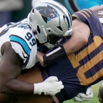 Carolina Panthers defensive tackle Tershawn Wharton (99) sacks Green Bay Packers quarterback Jordan Love.