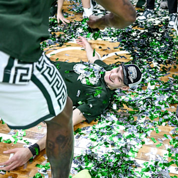 Michigan State's Carson Cooper does a confetti angel while celebrating the Spartans Big Ten championship after the game against Michigan on Sunday, March 9, 2025, at the Breslin Center in East Lansing.