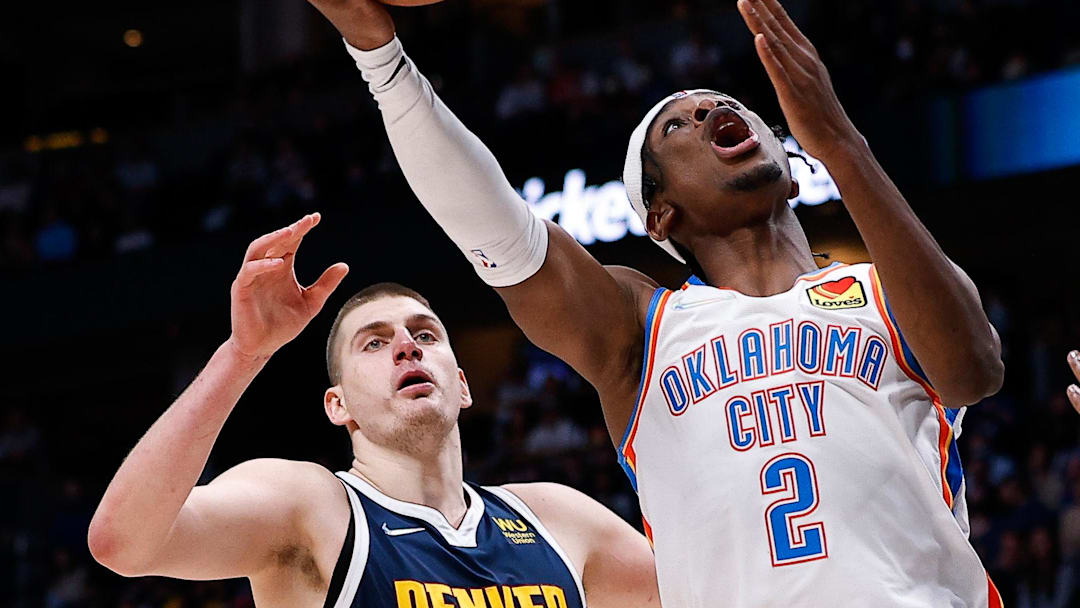 Mar 2, 2022; Denver, Colorado, USA; Oklahoma City Thunder guard Shai Gilgeous-Alexander (2) drives to the net against Denver Nuggets forward Will Barton (5) and center Nikola Jokic (15) in the fourth quarter at Ball Arena. Mandatory Credit: Isaiah J. Downing-Imagn Images