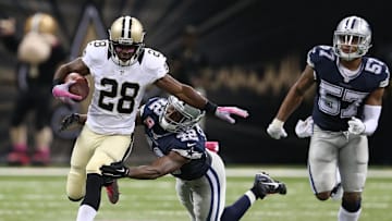 Oct 4, 2015; New Orleans, LA, USA; New Orleans Saints running back C.J. Spiller (28) breaks the tackle of Dallas Cowboys strong safety Barry Church (42) to score the game-winning 80-yard touchdown in overtime at Mercedes-Benz Superdome. The Saints won 26-20. Mandatory Credit: Chuck Cook-Imagn Images