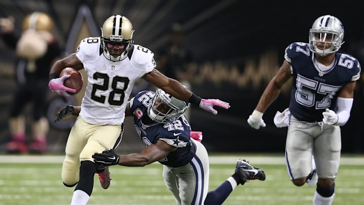 Oct 4, 2015; New Orleans, LA, USA; New Orleans Saints running back C.J. Spiller (28) breaks the tackle of Dallas Cowboys strong safety Barry Church (42) to score the game-winning 80-yard touchdown in overtime at Mercedes-Benz Superdome. The Saints won 26-20. Mandatory Credit: Chuck Cook-Imagn Images