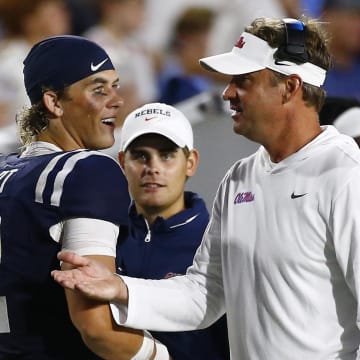 Aug 31, 2024; Oxford, Mississippi, USA; Mississippi Rebels head coach Lane Kiffin (right) talks to quarterback Jaxson Dart (2) during the second half against the Furman Paladins at Vaught-Hemingway Stadium. Mandatory Credit: Petre Thomas-USA TODAY Sports