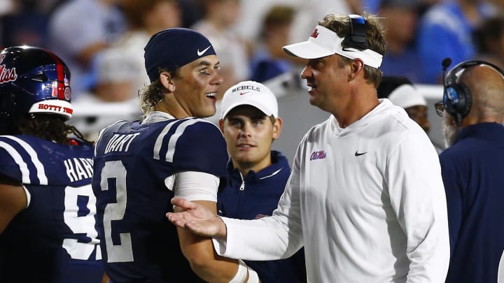 Aug 31, 2024; Oxford, Mississippi, USA; Mississippi Rebels head coach Lane Kiffin (right) talks to quarterback Jaxson Dart (2) during the second half against the Furman Paladins at Vaught-Hemingway Stadium. Mandatory Credit: Petre Thomas-USA TODAY Sports