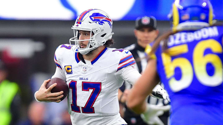 Buffalo Bills quarterback Josh Allen (17) runs the ball against the Los Angeles Rams defense. Mandatory Credit: Gary A. Vasquez-Imagn Images