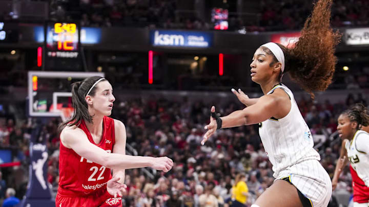 Indiana Fever guard Caitlin Clark passes around Chicago Sky forward Angel Reese. Indiana Fever guard Caitlin Clark passes around Chicago Sky forward Angel Reese.