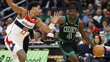 Boston Celtics guard Jrue Holiday (4) drives to the basket as Washington Wizards guard Jordan Poole (13) defends in the first half at Capital One Arena.