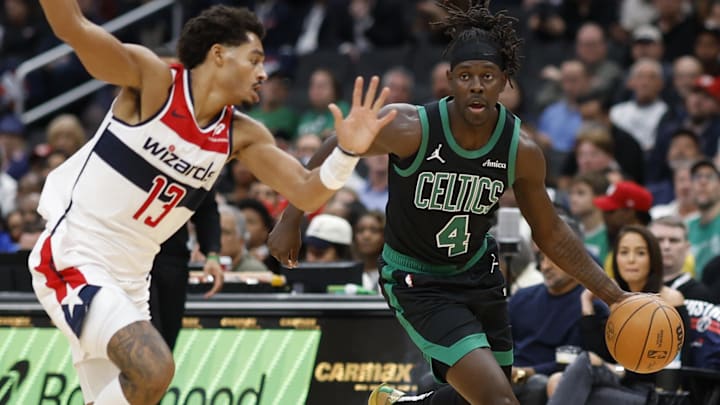 Boston Celtics guard Jrue Holiday (4) drives to the basket as Washington Wizards guard Jordan Poole (13) defends in the first half at Capital One Arena.