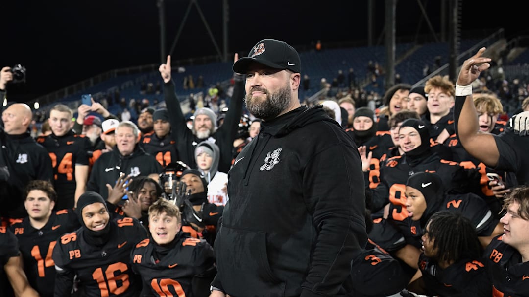 Massillon head coach Nate Moore and players look on during the postgame trophy presentations after winning the 2023 OHSAA Division II state championship with a 7-2 win over Archbishop Hoban.