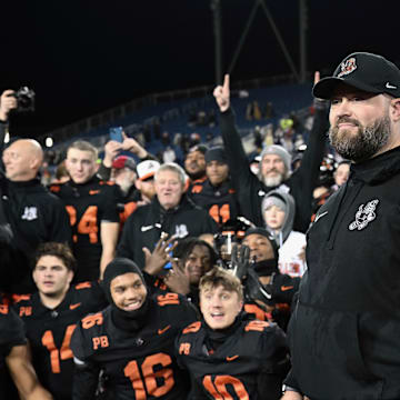 Massillon head coach Nate Moore and players look on during the postgame trophy presentations after winning the 2023 OHSAA Division II state championship with a 7-2 win over Archbishop Hoban.