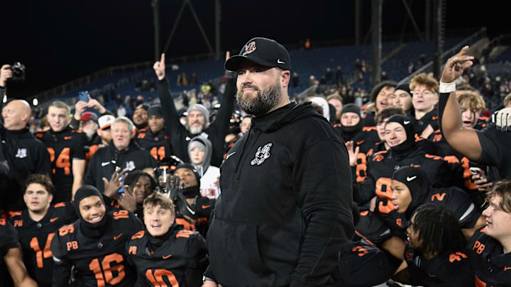 Massillon head coach Nate Moore and players look on during the postgame trophy presentations after winning the 2023 OHSAA Division II state championship with a 7-2 win over Archbishop Hoban.