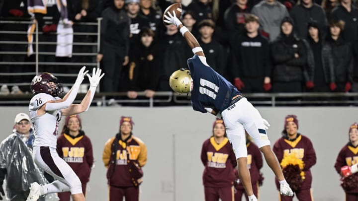 Elbert "Rock" Hill IV of Archbishop Hoban extends to break up a pass against Walsh Jesuit in the 2023 regional finals.