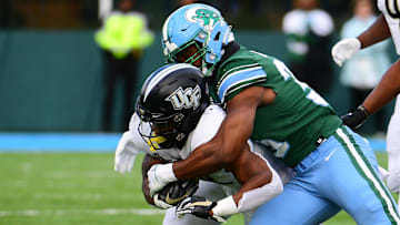 Nov 12, 2022; New Orleans, Louisiana, USA; Tulane Green Wave linebacker Jesus Machado (35) tackles UCF Knights running back RJ Harvey (22) during the second quarter at Yulman Stadium