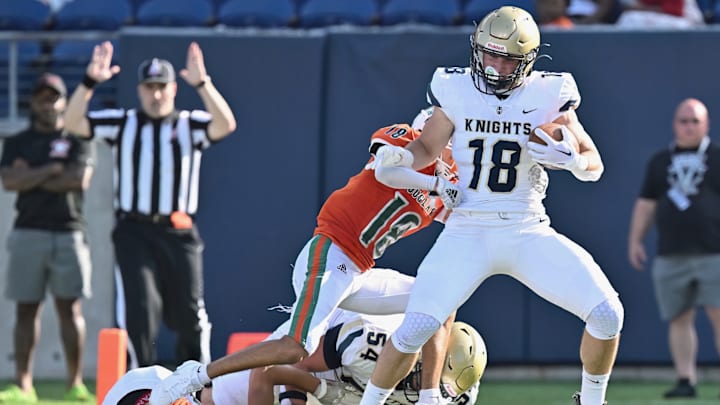 Archbishop Hoban running back Brayton Feister breaks the tackle of multiple defenders in a game against Frederick Douglass (Kentucky) on Aug. 19, 2023