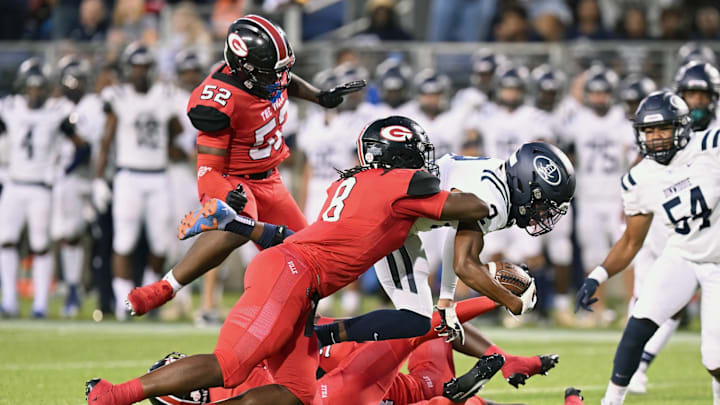 Glenville's Cincere Johnson (No. 8) makes a tackle against Dinwiddie (Kentucky) in a 2023 regular season game.