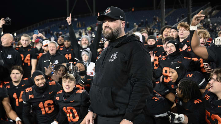 Massillon head coach Nate Moore and players look on during the postgame trophy presentations after winning the 2023 OHSAA Division II state championship with a 7-2 win over Archbishop Hoban.