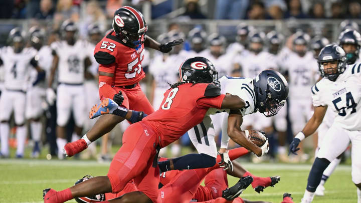 Glenville's Cincere Johnson (No. 8) makes a tackle against Dinwiddie (Kentucky) in a 2023 regular season game.