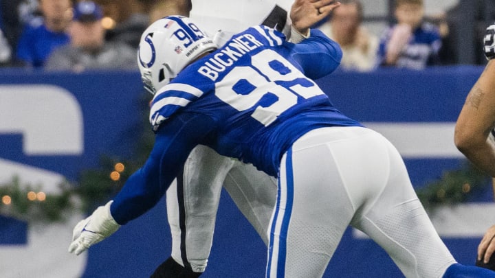 Dec 31, 2023; Indianapolis, Indiana, USA; Las Vegas Raiders quarterback Aidan O'Connell (4) passes the ball while Indianapolis Colts defensive tackle DeForest Buckner (99) defends in the first half at Lucas Oil Stadium. Mandatory Credit: Trevor Ruszkowski-USA TODAY Sports