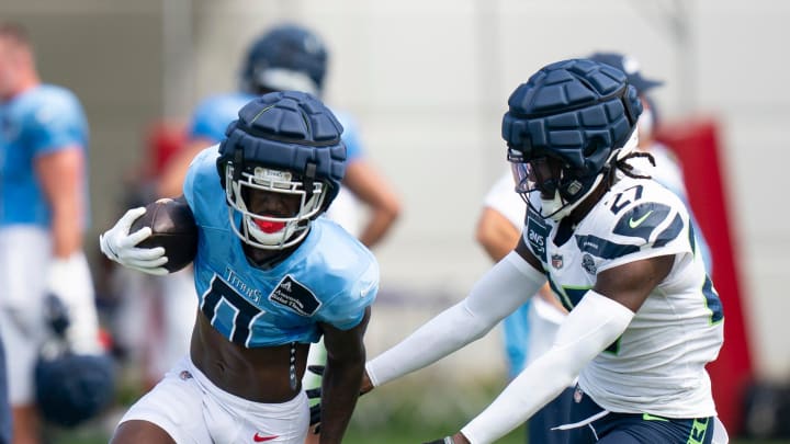 Tennessee Titans wide receiver Calvin Ridley (0) runs after a catch against Seattle Seahawks cornerback Riq Woolen (27) at Ascension Saint Thomas Sports Park in Nashville, Tenn., Wednesday, Aug. 14 2024. This is the first day of the Titans joint practice with the Seattle Seahawks.