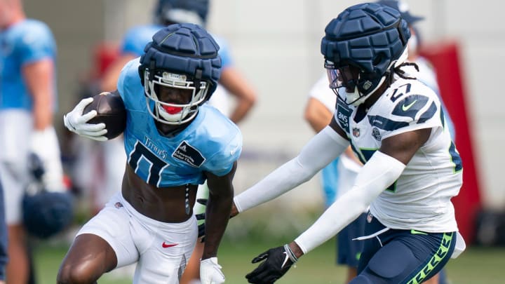 Tennessee Titans wide receiver Calvin Ridley (0) runs after a catch against Seattle Seahawks cornerback Riq Woolen (27) at Ascension Saint Thomas Sports Park in Nashville, Tenn., Wednesday, Aug. 14 2024. This is the first day of the Titans joint practice with the Seattle Seahawks.