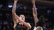 Dec 10, 2024; New York, New York, USA;  Miami  Hurricanes center Lynn Kidd (1) shoots over Tennessee Volunteers forward Felix Okpara (34) in the second half at Madison Square Garden. Mandatory Credit: Wendell Cruz-Imagn Images