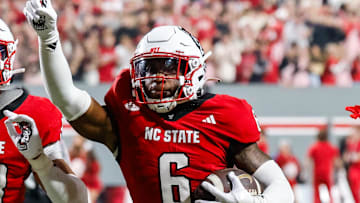 Nov 21, 2025; Raleigh, North Carolina, USA; NC State Wolfpack defensive back Devon Marshall (6) celebrates a down and runs towards the JROTC  to celebrate during the first half of the game against Florida State Seminoles at Carter-Finley Stadium. Mandatory Credit: Jaylynn Nash-Imagn Images