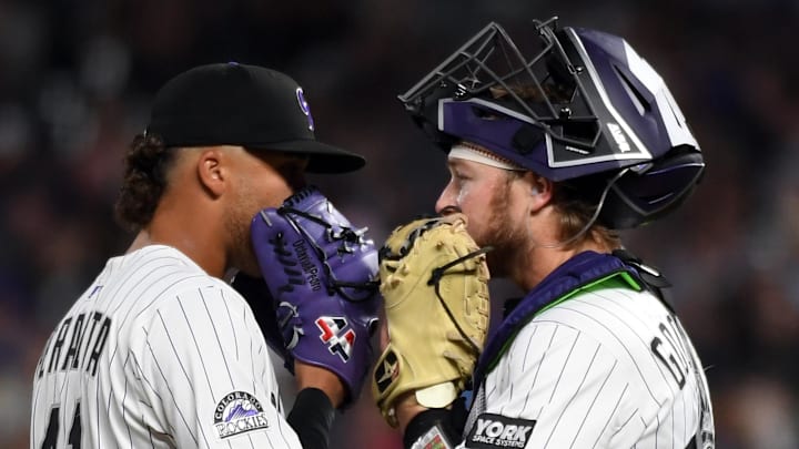 Aug 30, 2025; Denver, Colorado, USA; Colorado Rockies pitcher Luis Peralta (41) talks with catcher Hunter Goodman (15) during the seventh inning against the Chicago Cubs at Coors Field. 