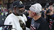 Nov 9, 2024; Lubbock, Texas, USA; Colorado Buffalos head coach Deion Sanders and Texas Tech Red Raiders head coach Joey McGuire after the game at Jones AT&T Stadium and Cody Campbell Field. Mandatory Credit: Michael C. Johnson-Imagn Images