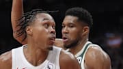 Toronto Raptors guard Scottie Barnes controls the ball against Milwaukee Bucks forward Giannis Antetokounmpo.