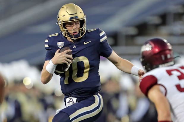 Akron Zips quarterback Ben Finley, center, scrambles for yards against Colgate during the first half of an NCAA college footb