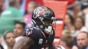 Houston Texans wide receiver Nico Collins runs with the ball as Tennessee Titans linebacker Cedric Gray defends