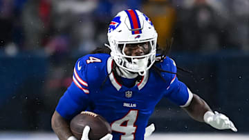 Jan 19, 2025; Orchard Park, New York, USA; Buffalo Bills running back James Cook (4) runs with the ball in the fourth quarter of a 2025 AFC divisional round game against the Baltimore Ravens at Highmark Stadium. Mandatory Credit: Mark Konezny-Imagn Images