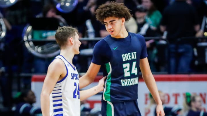 Spencer County's Camden Cox (24) and Great Crossing's Malachi Moreno (24) come together after the No.1 Warhawks rallied to beat the much smaller but tough Spencer team in the first round of the 2024 UK Healthcare KHSAA Boys' Sweet 16 in Lexington. March 20, 2024