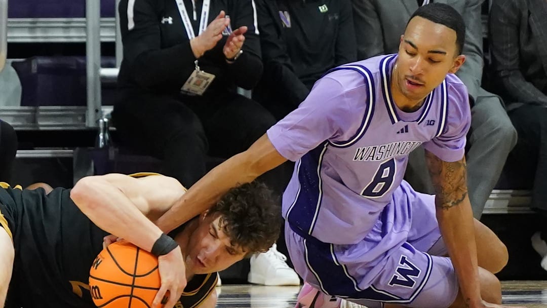 Jan 31, 2026; Evanston, Illinois, USA; Northwestern Wildcats forward Nick Martinelli (2) and Washington Huskies forward Bryson Tucker (8) go for a loose ball during the first half at Welsh-Ryan Arena. Mandatory Credit: David Banks-Imagn Images