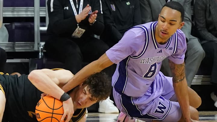 Jan 31, 2026; Evanston, Illinois, USA; Northwestern Wildcats forward Nick Martinelli (2) and Washington Huskies forward Bryson Tucker (8) go for a loose ball during the first half at Welsh-Ryan Arena. Mandatory Credit: David Banks-Imagn Images
