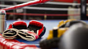 Boxing gloves on an empty ring.