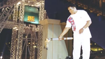 19 Jul 1996:  Muhammad Ali holds the torch before lighting the Olympic Flame during the Opening Cere