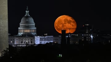 The moon rises over US capital of Washington DC